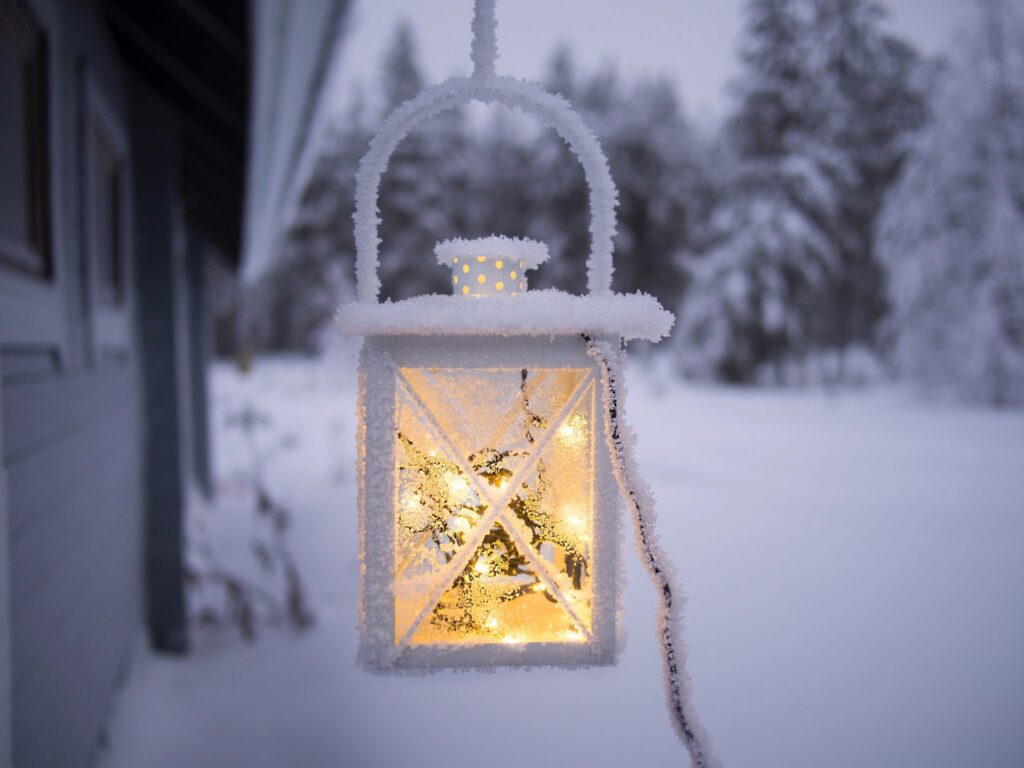 A snowy scene and frosty outdoor latern to signify less light during winter affecting sleep.