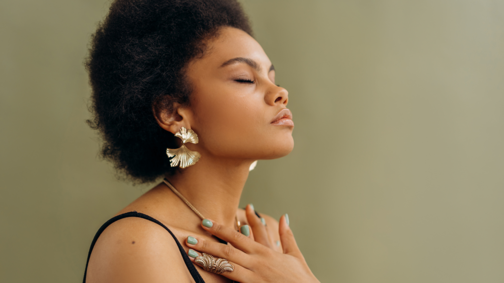 Woman with her eyes shut and her hand crossed against her chest, meditating