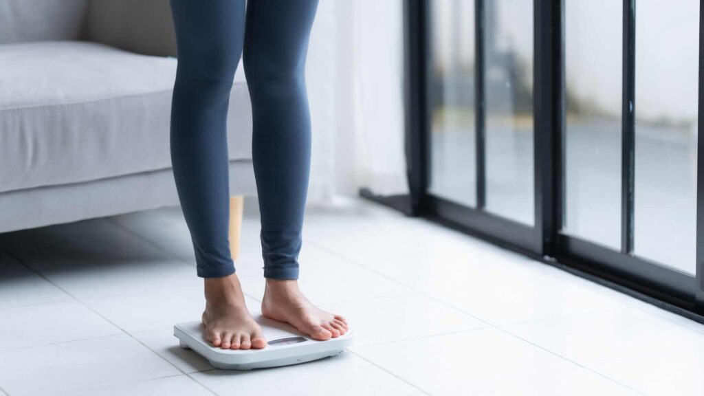 Legs on a scales to denote weight loss or weight gain