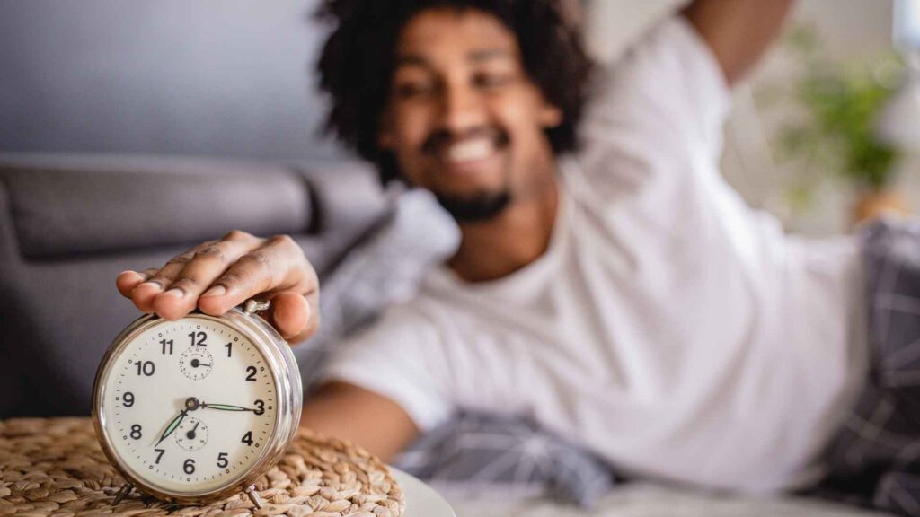Man waking up and smiling in his perfect morning routine